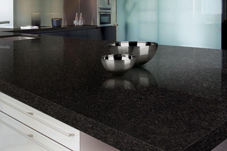 Clean stainless steel bowls atop a clean granite countertop