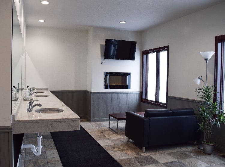 Lounge with granite floors and granite hand washing sinks